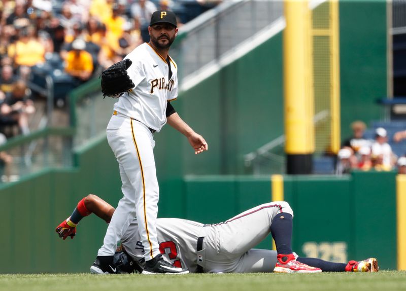 May 26, 2024; Pittsburgh, Pennsylvania, USA;  Pittsburgh Pirates starting pitcher Martín Pérez (54) calls to the Atlanta Braves dugout as Braves right fielder Ronald Acuña Jr. (13) reacts after suffering an apparent injury on a steal attempt during the first inning at PNC Park. Mandatory Credit: Charles LeClaire-USA TODAY Sports