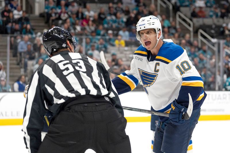 Oct 10, 2024; San Jose, California, USA;  St. Louis Blues center Brayden Schenn (10) argues with linesman Bevan Mills (53) during the third period against the San Jose Sharks at SAP Center at San Jose. Mandatory Credit: Stan Szeto-Imagn Images