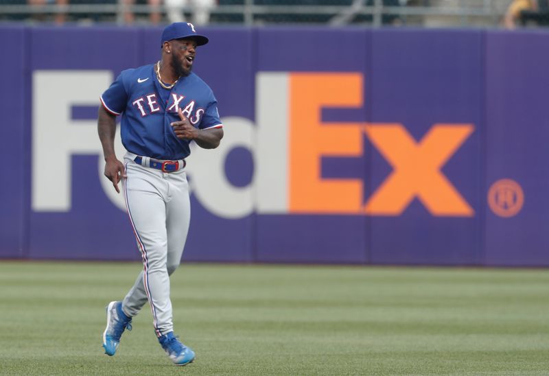 May 23, 2023; Pittsburgh, Pennsylvania, USA; Texas Rangers right fielder Adolis Garcia (53) warms up in the outfield before the game against the Pittsburgh Pirates at PNC Park. Mandatory Credit: Charles LeClaire-USA TODAY Sports