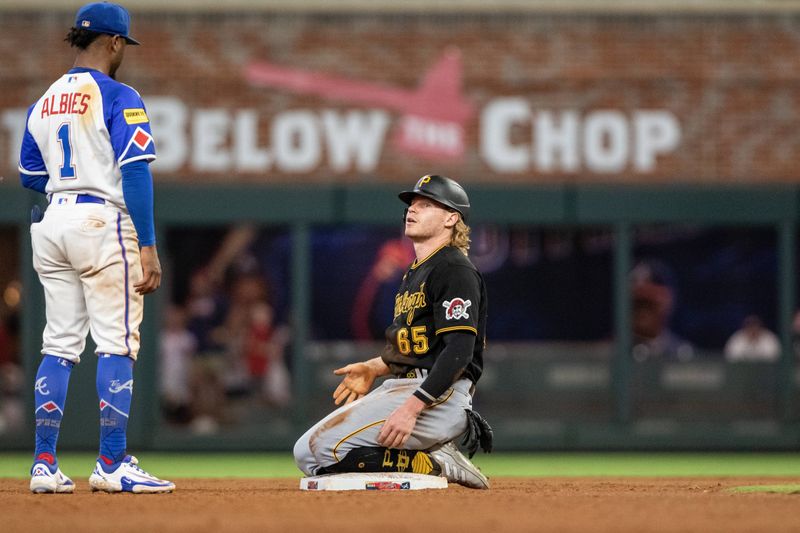 Sep 9, 2023; Cumberland, Georgia, USA; Pittsburgh Pirates center fielder Jack Suwinski (65) steals second base against Atlanta Braves second baseman Ozzie Albies (1) in eighth inning at Truist Park. Mandatory Credit: Jordan Godfree-USA TODAY Sports