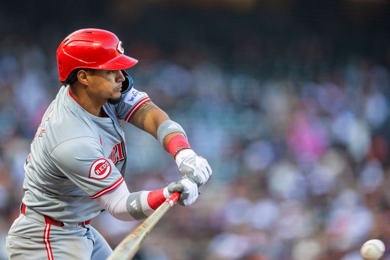 May 11, 2024; San Francisco, California, USA; Cincinnati Reds second base Santiago Espinal (4) singles against the San Francisco Giants during the ninth inning at Oracle Park. Mandatory Credit: Bob Kupbens-USA TODAY Sports