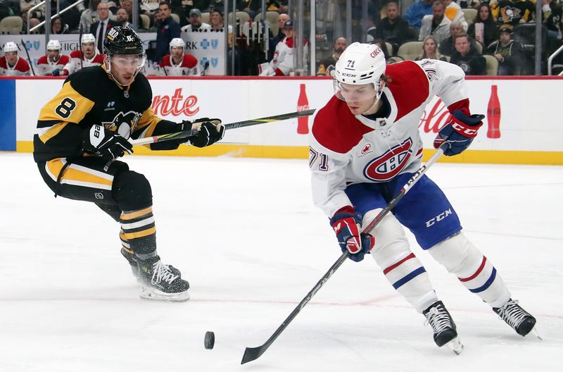 Nov 2, 2024; Pittsburgh, Pennsylvania, USA;  Montreal Canadiens center Jake Evans (71) handles the puck against Pittsburgh Penguins left wing Michael Bunting (8) during the third period at PPG Paints Arena. Mandatory Credit: Charles LeClaire-Imagn Images