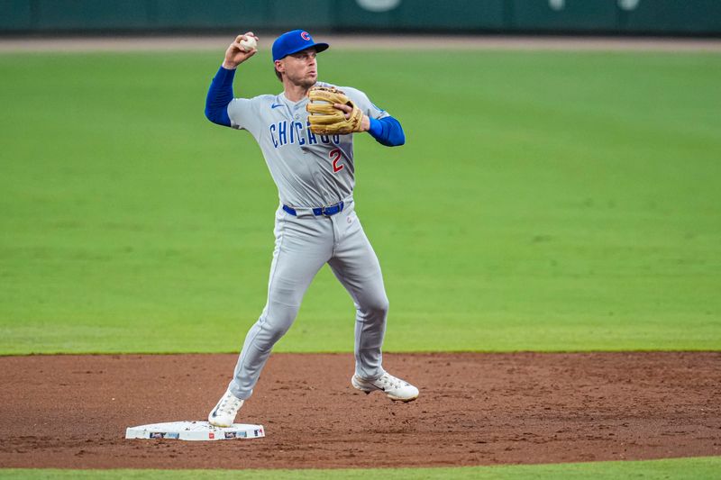Sep 10, 2025; Cumberland, Georgia, USA; Chicago Cubs second baseman Nico Hoerner (2) completes a throw for a double play against the Atlanta Braves during the first inning at Truist Park. Mandatory Credit: Dale Zanine-Imagn Images