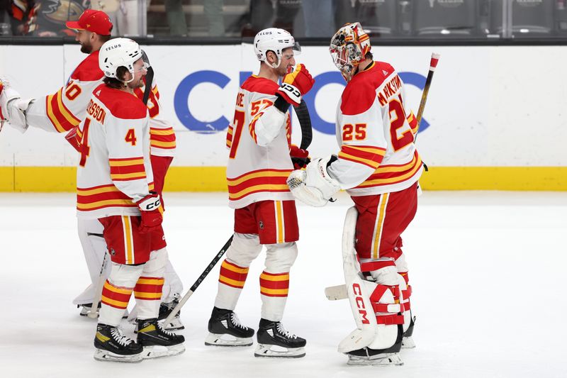 Dec 21, 2023; Anaheim, California, USA;  Calgary Flames goaltender Jacob Markstrom (25) celebrates a victory with defenseman Nick DeSimone (57) after beating the Anaheim Ducks 3-0 at Honda Center. Mandatory Credit: Kiyoshi Mio-USA TODAY Sports