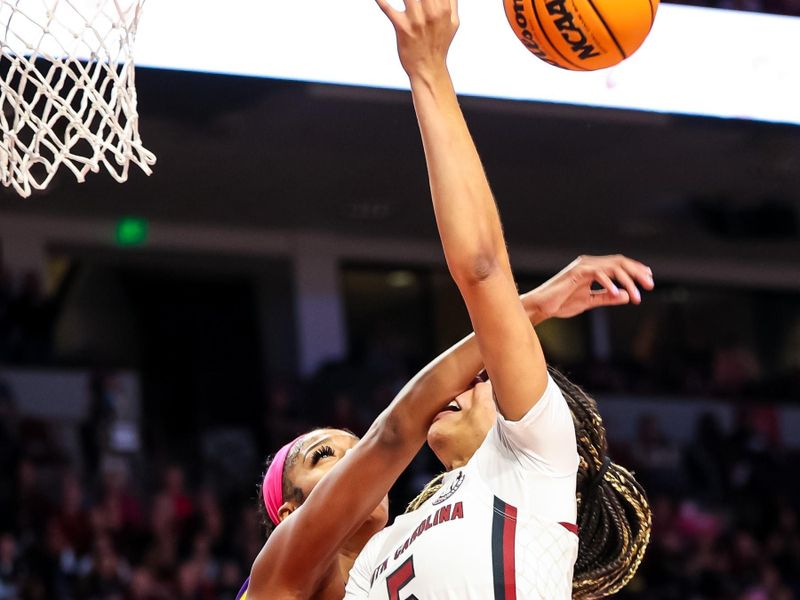 Feb 12, 2023; Columbia, South Carolina, USA; LSU Lady Tigers forward Angel Reese (10) blocks the shot of South Carolina Gamecocks forward Victaria Saxton (5) in the first half at Colonial Life Arena. Mandatory Credit: Jeff Blake-USA TODAY Sports