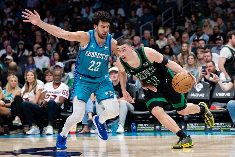 CHARLOTTE, NORTH CAROLINA - APRIL 01: Vasa Micic #22 of the Charlotte Hornets guards Payton Pritchard #11 of the Boston Celtics in the fourth quarter during their game at Spectrum Center on April 01, 2024 in Charlotte, North Carolina. NOTE TO USER: User expressly acknowledges and agrees that, by downloading and or using this photograph, User is consenting to the terms and conditions of the Getty Images License Agreement. (Photo by Jacob Kupferman/Getty Images)