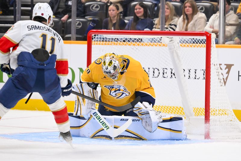 Nov 24, 2025; Nashville, Tennessee, USA;  Nashville Predators goaltender Justus Annunen (29) blocks the shot of Florida Panthers right wing Mackie Samoskevich (11) during the second period at Bridgestone Arena. Mandatory Credit: Steve Roberts-Imagn Images
