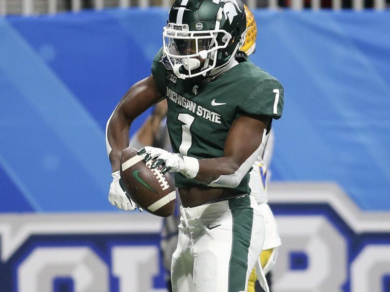 Dec 30, 2021; Atlanta, GA, USA; Michigan State Spartans wide receiver Jayden Reed (1) celebrates after a touchdown catch against the Pittsburgh Panthers in the first quarter during the 2021 Peach Bowl at Mercedes-Benz Stadium. Mandatory Credit: Brett Davis-USA TODAY Sports