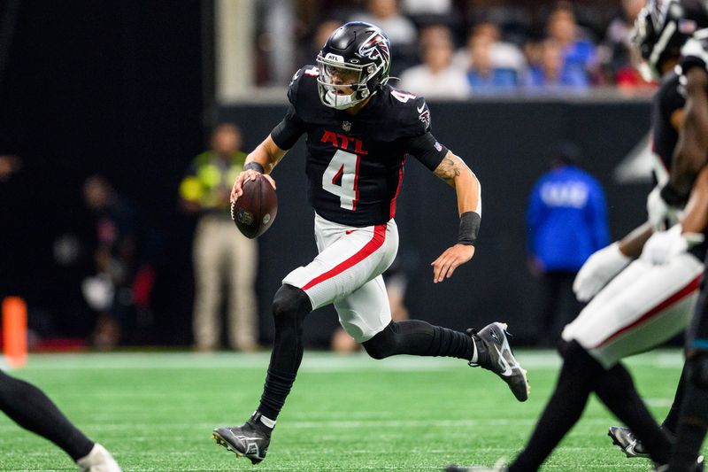 Atlanta Falcons quarterback Desmond Ridder (4) works during the first half of an NFL football game against the Jacksonville Jaguars, Saturday, Aug. 27, 2022, in Atlanta. The Atlanta Falcons won 28-12. (AP Photo/Danny Karnik)