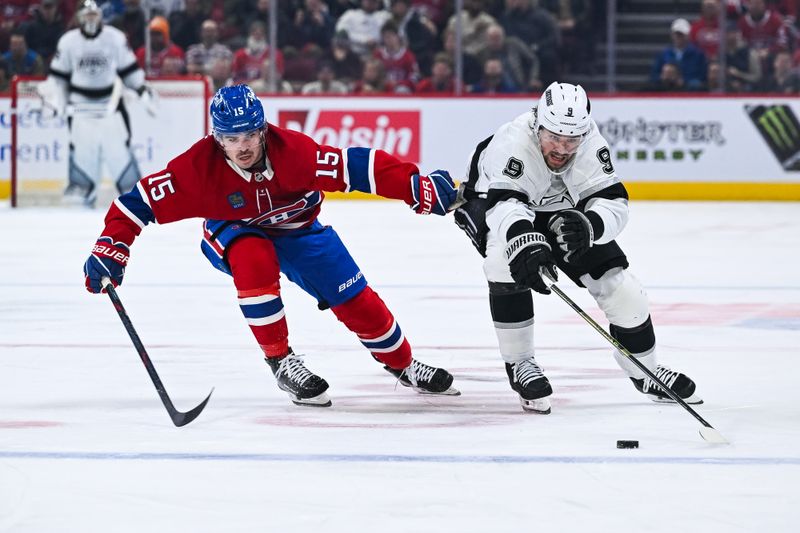 Nov 11, 2025; Montreal, Quebec, CAN; Los Angeles Kings right wing Adrian Kempe (9) plays the puck against Montreal Canadiens center Alex Newhook (15) during the second period at Bell Centre. Mandatory Credit: David Kirouac-Imagn Images