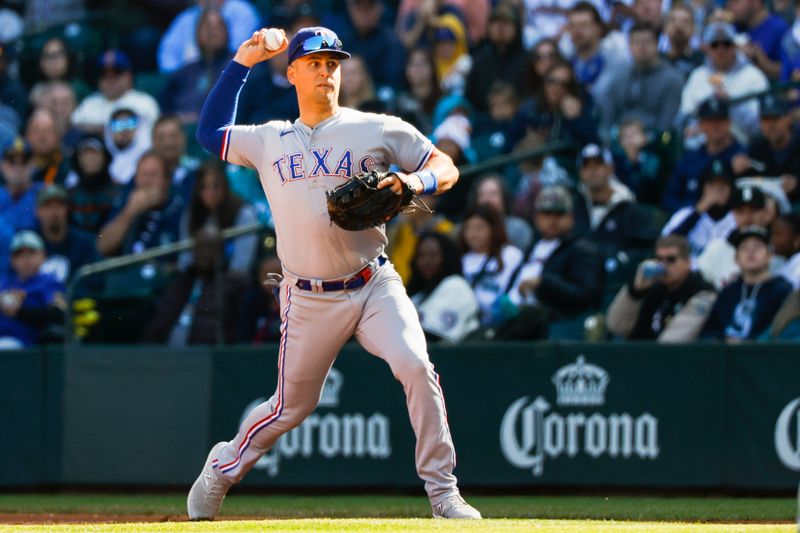 Oct 1, 2023; Seattle, Washington, USA; Texas Rangers first baseman Nathaniel Lowe (30) throws home to attempt a double play against the Seattle Mariners during the fourth inning at T-Mobile Park. Mandatory Credit: Joe Nicholson-USA TODAY Sports