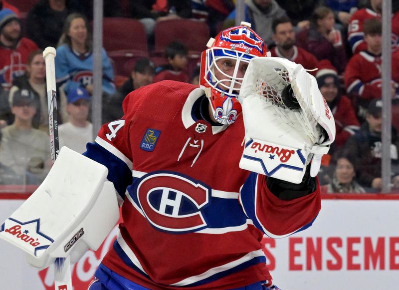 Feb 11, 2024; Montreal, Quebec, CAN; Montreal Canadiens goalie Jake Allen (34) makes a glove save during the first period of the game against the St.Louis Blues at the Bell Centre. Mandatory Credit: Eric Bolte-USA TODAY Sports