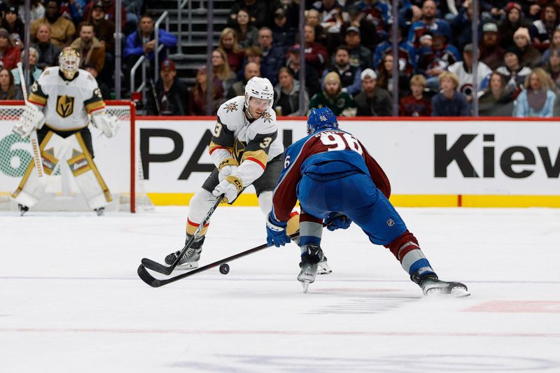 Nov 27, 2024; Denver, Colorado, USA; Vegas Golden Knights defenseman Brayden McNabb (3) and Colorado Avalanche right wing Mikko Rantanen (96) battle for the puck in the third period at Ball Arena. Mandatory Credit: Isaiah J. Downing-Imagn Images