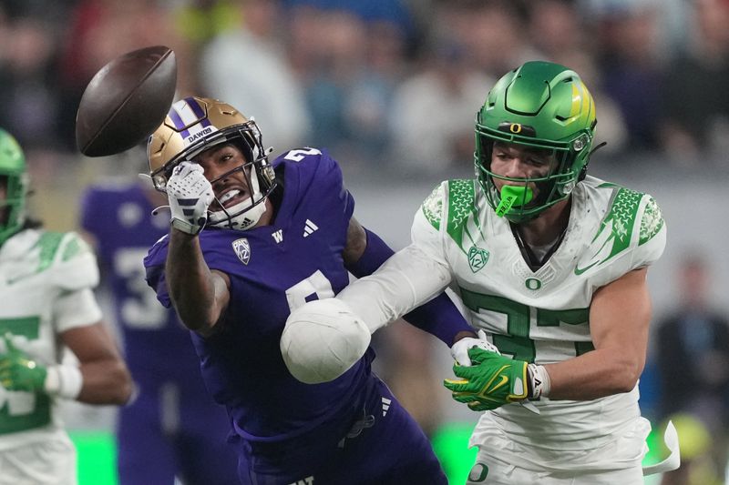 Dec 1, 2023; Las Vegas, NV, USA; Washington Huskies wide receiver Ja'Lynn Polk (2) attempts to catch the ball against Oregon Ducks defensive back Evan Williams (33) in the first half at Allegiant Stadium. Mandatory Credit: Kirby Lee-USA TODAY Sports