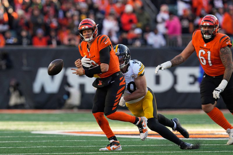 Pittsburgh Steelers linebacker T.J. Watt (90) forces a fumble by Cincinnati Bengals quarterback Joe Burrow, left, during the first half of an NFL football game Sunday, Dec. 1, 2024, in Cincinnati. (AP Photo/Jeff Dean)