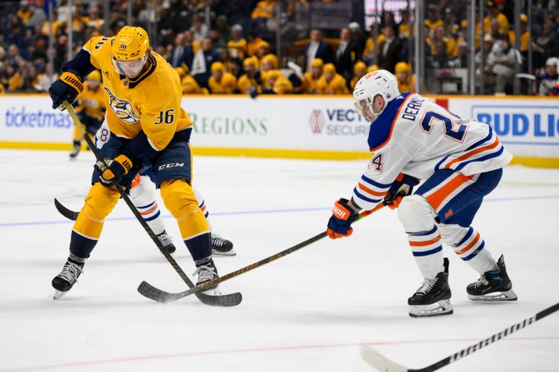 Oct 31, 2024; Nashville, Tennessee, USA;  Edmonton Oilers defenseman Travis Dermott (24) pokes the puck from Nashville Predators left wing Cole Smith (36) during the third period at Bridgestone Arena. Mandatory Credit: Steve Roberts-Imagn Images