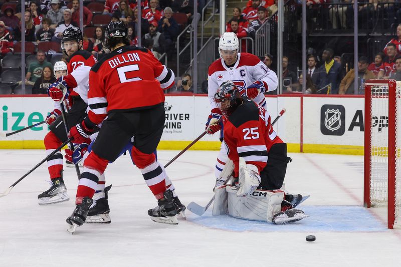 Nov 7, 2024; Newark, New Jersey, USA; New Jersey Devils goaltender Jacob Markstrom (25) makes a save against the Montreal Canadiens during the third period at Prudential Center. Mandatory Credit: Ed Mulholland-Imagn Images