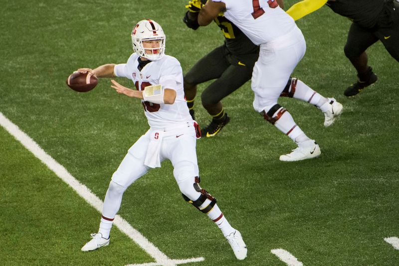 Nov 7, 2020; Eugene, Oregon, USA; Stanford Cardinal quarterback Tanner McKee (18) throws a pass during the first half against the Oregon Ducks at Autzen Stadium. Mandatory Credit: Troy Wayrynen-USA TODAY Sports