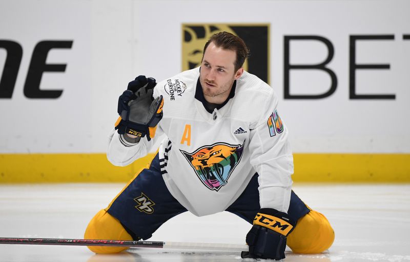 Apr 4, 2023; Nashville, Tennessee, USA; Nashville Predators center Colton Sissons (10) stretches while wearing Pride Night jerseys before the game against the Vegas Golden Knights at Bridgestone Arena. Mandatory Credit: Christopher Hanewinckel-USA TODAY Sports