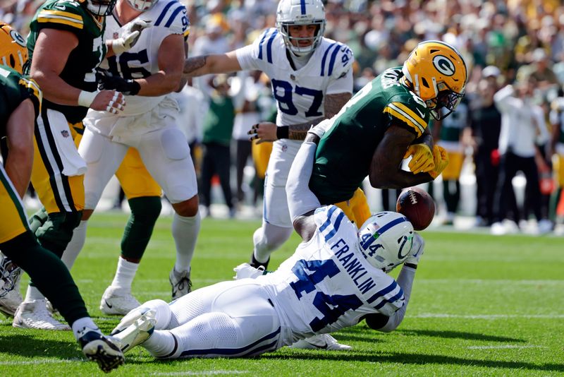 Green Bay Packers running back Josh Jacobs (8) fumbles as he is tackled by Indianapolis Colts linebacker Zaire Franklin (44) during the first half of an NFL football game Sunday, Sept. 15, 2024, in Green Bay, Wis. (AP Photo/Matt Ludtke)