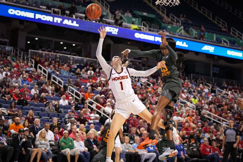 Mar 8, 2024; Greensboro, NC, USA; Miami Hurricanes forward Latasha Lattimore (35) blocks the attempted shot of Virginia Tech Hokies guard Carleigh Wenzel (1) in the first half at Greensboro Coliseum. Mandatory Credit: David Yeazell-USA TODAY Sports