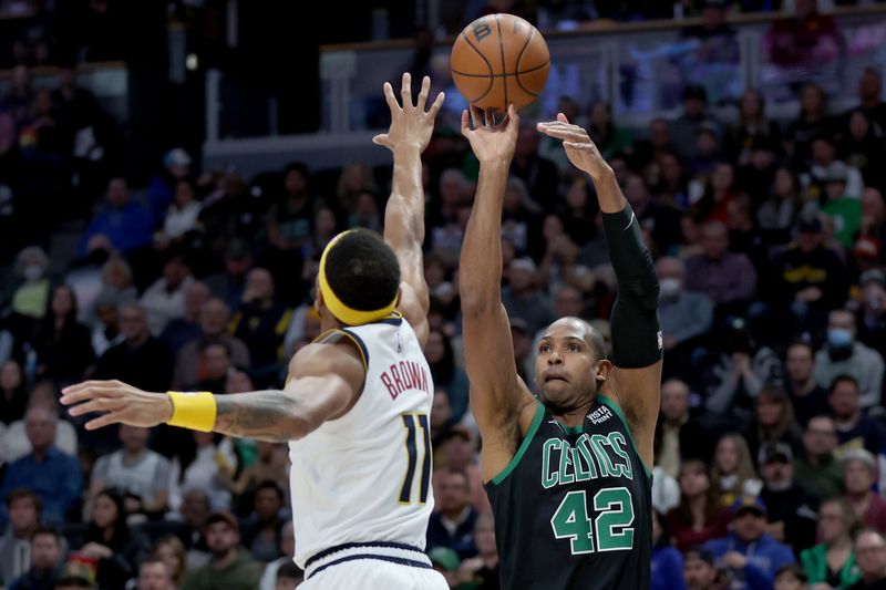 DENVER, COLORADO - JANUARY 01: Al Horford #42 of the Boston Celtics puts up a basket against Bruce Brown #11 of the Denver Nuggets during the first quarter at Ball Arena on January 01, 2023 in Denver, Colorado. NOTE TO USER: User expressly acknowledges and agrees that, by downloading and/or using this photograph, User is consenting to the terms and conditions of the Getty Images License Agreement. (Photo by Matthew Stockman/Getty Images)