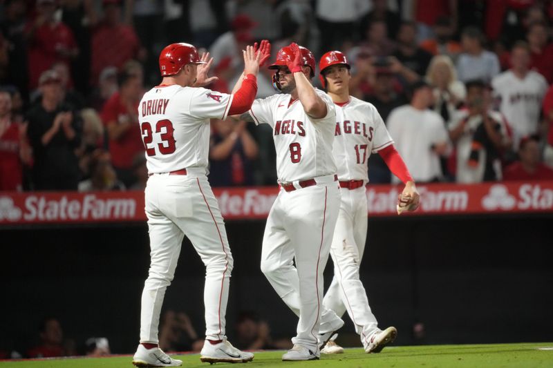 Aug 9, 2023; Anaheim, California, USA; Los Angeles Angels third baseman Mike Moustakas (8) celebrates with second baseman Brandon Drury (23) and starting pitcher Shohei Ohtani (17) after hitting a three-run home run in the sixth inning against the San Francisco Giants  at Angel Stadium. Mandatory Credit: Kirby Lee-USA TODAY Sports