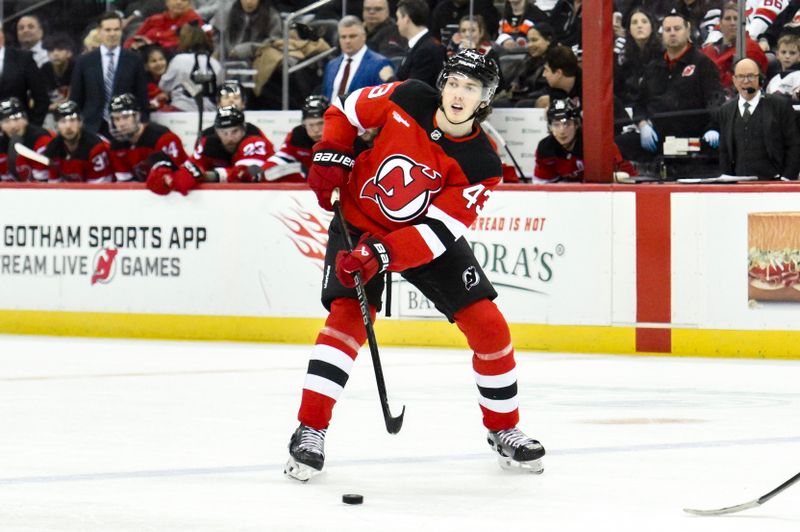 Jan 29, 2025; Newark, New Jersey, USA; New Jersey Devils defenseman Luke Hughes (43) passes the puck against the Philadelphia Flyers during the third period at Prudential Center. Mandatory Credit: John Jones-Imagn Images