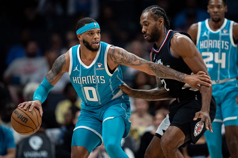 CHARLOTTE, NORTH CAROLINA - MARCH 31: Kawhi Leonard #2 of the LA Clippers guards Miles Bridges #0 of the Charlotte Hornets in the first quarter during their game at Spectrum Center on March 31, 2024 in Charlotte, North Carolina. NOTE TO USER: User expressly acknowledges and agrees that, by downloading and or using this photograph, User is consenting to the terms and conditions of the Getty Images License Agreement. (Photo by Jacob Kupferman/Getty Images)