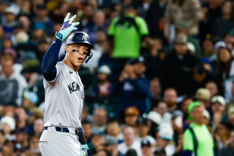 Sep 17, 2024; Seattle, Washington, USA; New York Yankees designated hitter Aaron Judge (99) reacts towards the Yankee dugout after hitting a tow-run single against the Seattle Mariners during the second inning at T-Mobile Park. Mandatory Credit: Joe Nicholson-Imagn Images