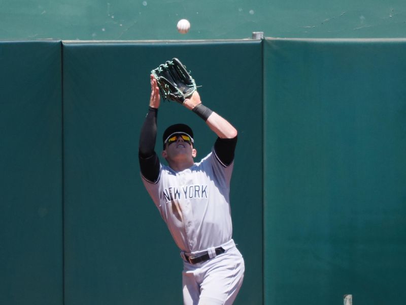 Jun 29, 2023; Oakland, California, USA; New York Yankees center fielder Harrison Bader (22) catches the ball against the Oakland Athletics during the sixth inning at Oakland-Alameda County Coliseum. Mandatory Credit: Kelley L Cox-USA TODAY Sports