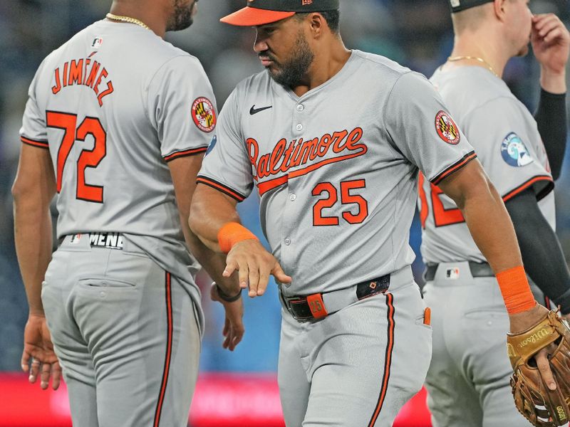 Aug 7, 2024; Toronto, Ontario, CAN; Baltimore Orioles right fielder Anthony Santander (25) celebrates the win with designated hitter Eloy Jiménez (72) against the Toronto Blue Jays at the end of he ninth inning at Rogers Centre. Mandatory Credit: Nick Turchiaro-USA TODAY Sports