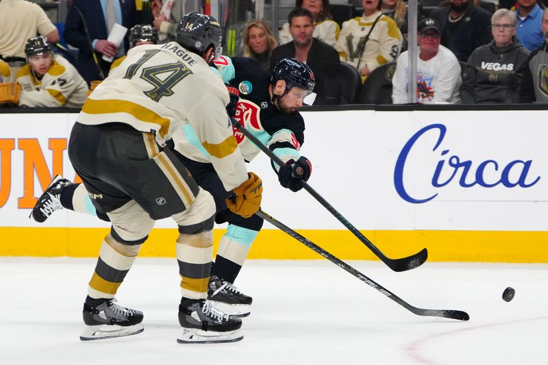 Mar 21, 2024; Las Vegas, Nevada, USA; Seattle Kraken left wing Tomas Tatar (90) shoots against the stick of Vegas Golden Knights defenseman Nicolas Hague (14) during the third period at T-Mobile Arena. Mandatory Credit: Stephen R. Sylvanie-USA TODAY Sports