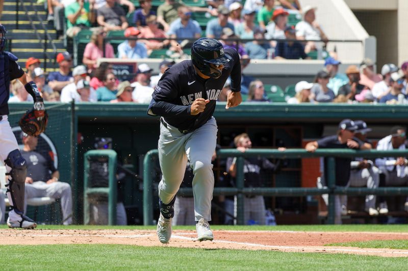 Mar 23, 2024; Lakeland, Florida, USA; New York Yankees center fielder Trent Grisham (12) runs to first during the second inning against the Detroit Tigers at Publix Field at Joker Marchant Stadium. Mandatory Credit: Mike Watters-USA TODAY Sports