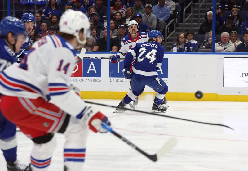 Nov 12, 2025; Tampa, Florida, USA; New York Rangers center Sam Carrick (39) passes the puck past Tampa Bay Lightning defenseman Max Crozier (24) to New York Rangers right wing Taylor Raddysh (14) during the second period at Benchmark International Arena. Mandatory Credit: Kim Klement Neitzel-Imagn Images
