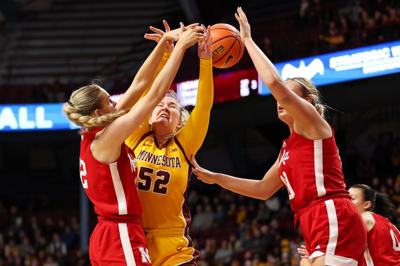 Jan 14, 2024; Minneapolis, Minnesota, USA; Minnesota Golden Gophers center Sophie Hart (52) loses control of the ball as Nebraska Cornhuskers forward Natalie Potts (22) and center Alexis Markowski (40) defend during the first half at Williams Arena. Mandatory Credit: Matt Krohn-USA TODAY Sports