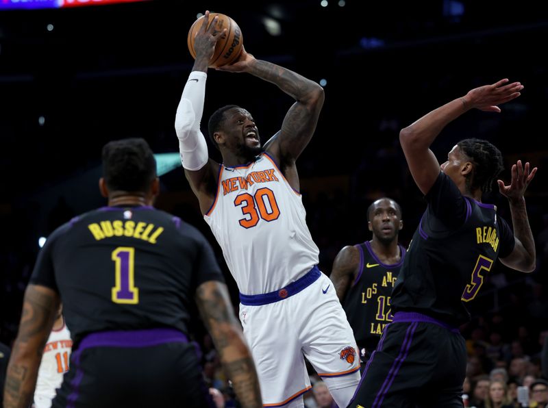 LOS ANGELES, CALIFORNIA - DECEMBER 18: Julius Randle #30 of the New York Knicks reacts on his shot in front of Cam Reddish #5 and D'Angelo Russell #1 of the Los Angeles Lakers during the first half at Crypto.com Arena on December 18, 2023 in Los Angeles, California. NOTE TO USER: User expressly acknowledges and agrees that, by downloading and or using this photograph, User is consenting to the terms and conditions of the Getty Images License Agreement. (Photo by Harry How/Getty Images)