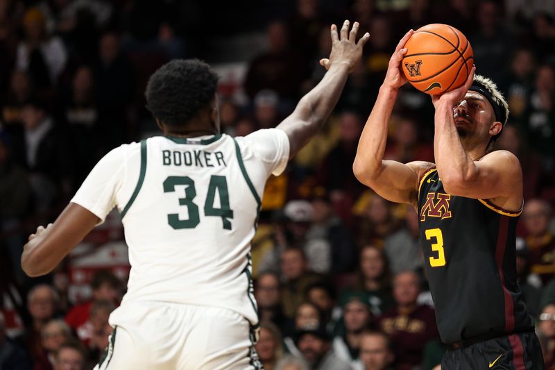 Dec 4, 2024; Minneapolis, Minnesota, USA; Minnesota Golden Gophers forward Dawson Garcia (3) shoots as Michigan State Spartans forward Xavier Booker (34) defends during the first half at Williams Arena. Mandatory Credit: Matt Krohn-Imagn Images