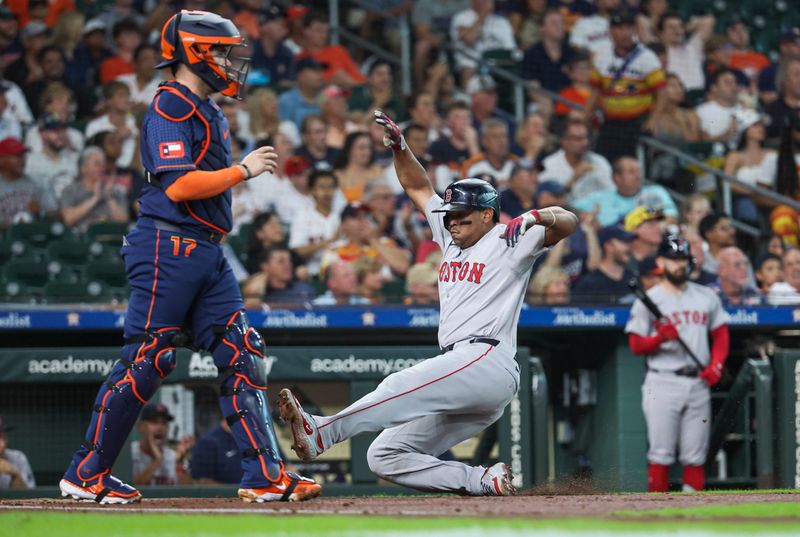 Aug 19, 2024; Houston, Texas, USA; Boston Red Sox third baseman Rafael Devers (11) slides past Houston Astros catcher Victor Caratini (17) to score a run during the first inning at Minute Maid Park. Mandatory Credit: Troy Taormina-USA TODAY Sports