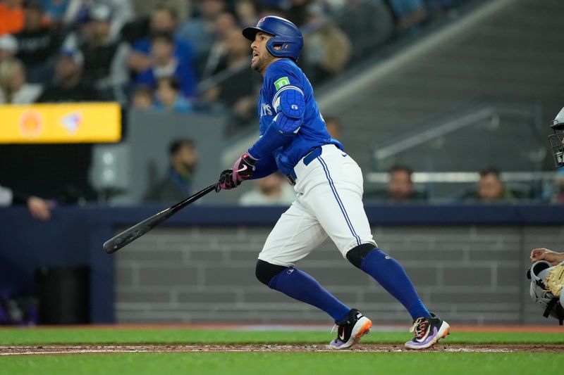 Apr 14, 2024; Toronto, Ontario, CAN; Toronto Blue Jays right fielder George Springer (4) hits a single against the Colorado Rockies during the first inning at Rogers Centre. Mandatory Credit: John E. Sokolowski-USA TODAY Sports