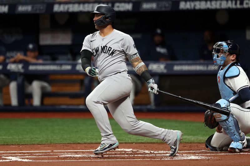 Jul 9, 2024; St. Petersburg, Florida, USA;  New York Yankees second base Gleyber Torres (25) hits an RBI single against the Tampa Bay Rays during the first inning at Tropicana Field. Mandatory Credit: Kim Klement Neitzel-USA TODAY Sports