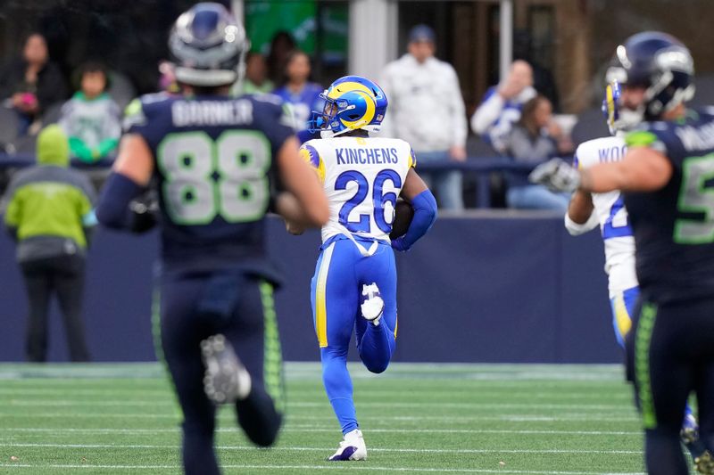 Los Angeles Rams safety Kamren Kinchens (26) returns an interception for a touchdown during the second half of an NFL football game against the Seattle Seahawks in Seattle, Sunday, Nov. 3, 2024. (AP Photo/Stephen Brashear)