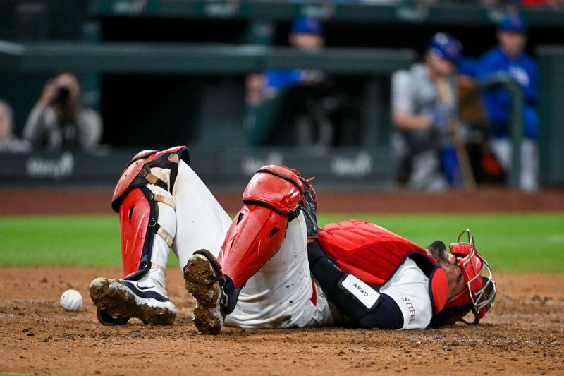 May 26, 2024; St. Louis, Missouri, USA;  St. Louis Cardinals catcher Ivan Herrera (48) falls to the ground after he was hit by a foul ball during the fourth inning against the Chicago Cubs at Busch Stadium. Mandatory Credit: Jeff Curry-USA TODAY Sports