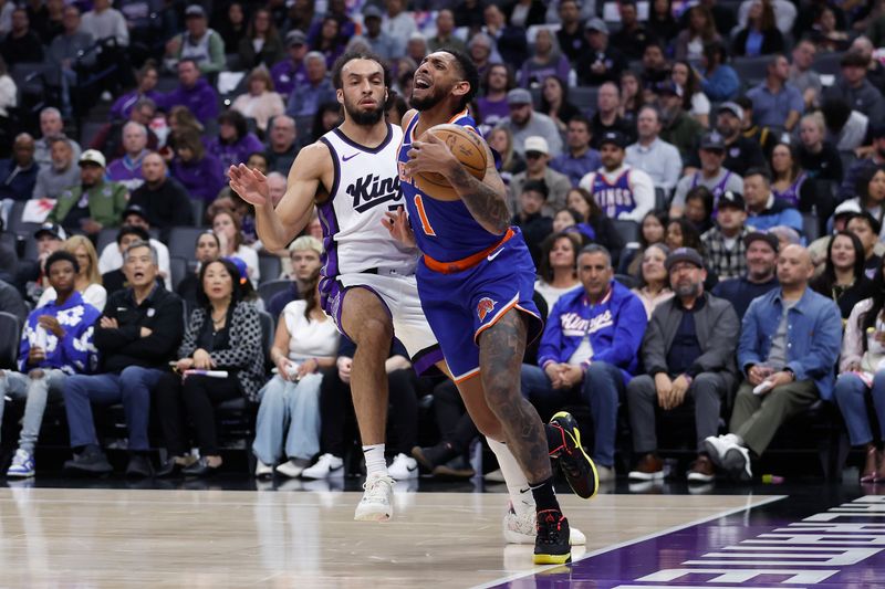 SACRAMENTO, CALIFORNIA - MARCH 10: Cameron Payne #1 of the New York Knicks steps out of bounds while going to the basket against Devin Carter #22 of the Sacramento Kings in the first half at Golden 1 Center on March 10, 2025 in Sacramento, California. NOTE TO USER: User expressly acknowledges and agrees that, by downloading and or using this photograph, User is consenting to the terms and conditions of the Getty Images License Agreement. (Photo by Lachlan Cunningham/Getty Images)