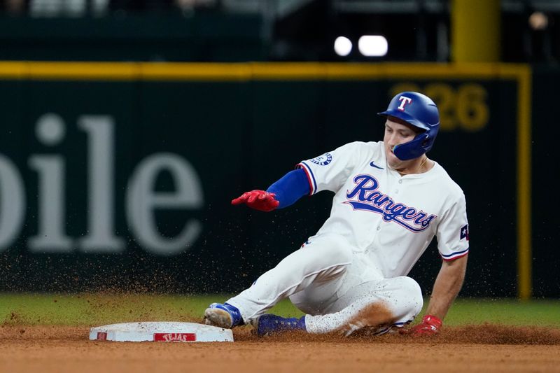 Jul 22, 2024; Arlington, Texas, USA; Texas Rangers left fielder Wyatt Langford (36) slides into second base with a double during the ninth inning against the Chicago White Sox at Globe Life Field. Mandatory Credit: Raymond Carlin III-USA TODAY Sports