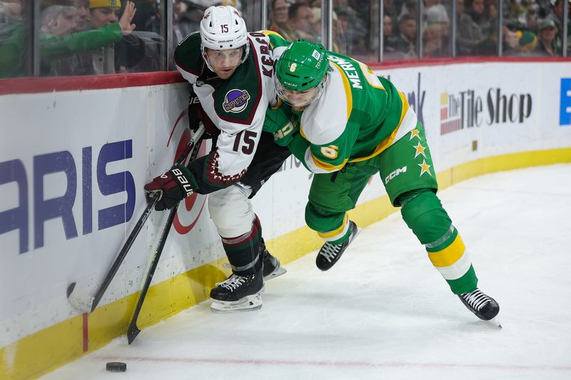 Jan 13, 2024; Saint Paul, Minnesota, USA; Arizona Coyotes center Alexander Kerfoot (15) and Minnesota Wild defenseman Dakota Mermis (6) compete for the puck during the first period at Xcel Energy Center. Mandatory Credit: Matt Krohn-USA TODAY Sports