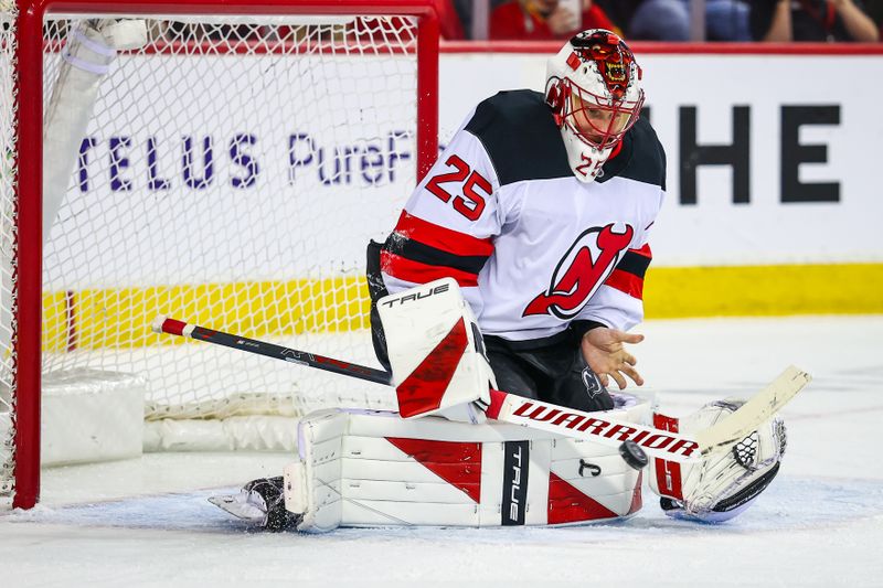 Jan 19, 2026; Calgary, Alberta, CAN; New Jersey Devils goaltender Jacob Markstrom (25) makes a save against the Calgary Flames during the second period at Scotiabank Saddledome. Mandatory Credit: Sergei Belski-Imagn Images