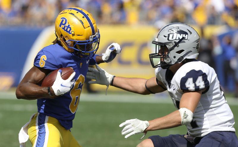 Sep 25, 2021; Pittsburgh, Pennsylvania, USA;  Pittsburgh Panthers wide receiver Tre Tipton (6) runs after a catch as New Hampshire Wildcats defensive back Noah Palm (44) defends during the third quarter at Heinz Field. Pittsburgh won 77-7.  Mandatory Credit: Charles LeClaire-USA TODAY Sports