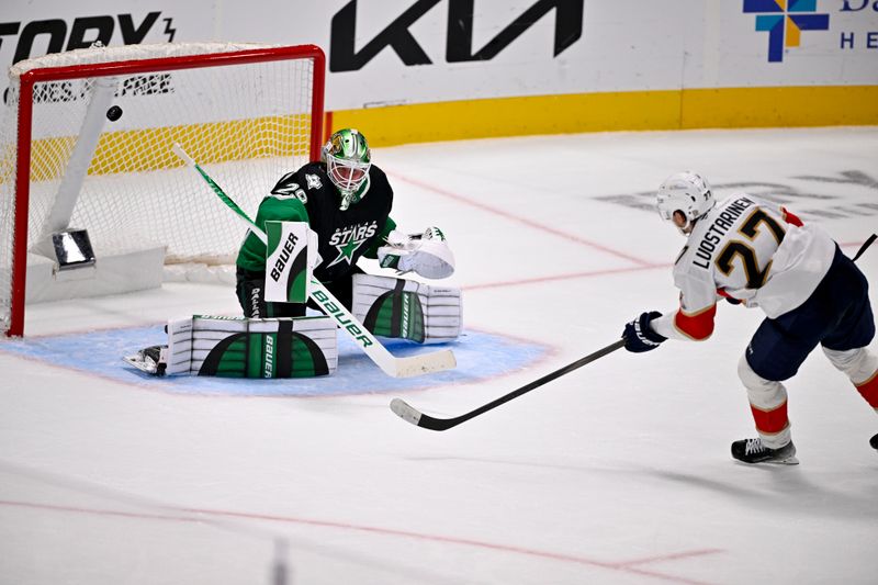 Dec 13, 2025; Dallas, Texas, USA; A shot by Florida Panthers center Eetu Luostarinen (27) hits the crossbar behind Dallas Stars goaltender Jake Oettinger (29) during the second period at the American Airlines Center. Mandatory Credit: Jerome Miron-Imagn Images