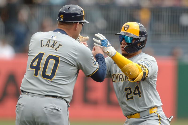 Apr 25, 2024; Pittsburgh, Pennsylvania, USA;  Milwaukee Brewers third base coach Jason Lane (40) congratulates catcher William Contreras (24) on his solo home run against the Pittsburgh Pirates during the first inning at PNC Park. Mandatory Credit: Charles LeClaire-USA TODAY Sports